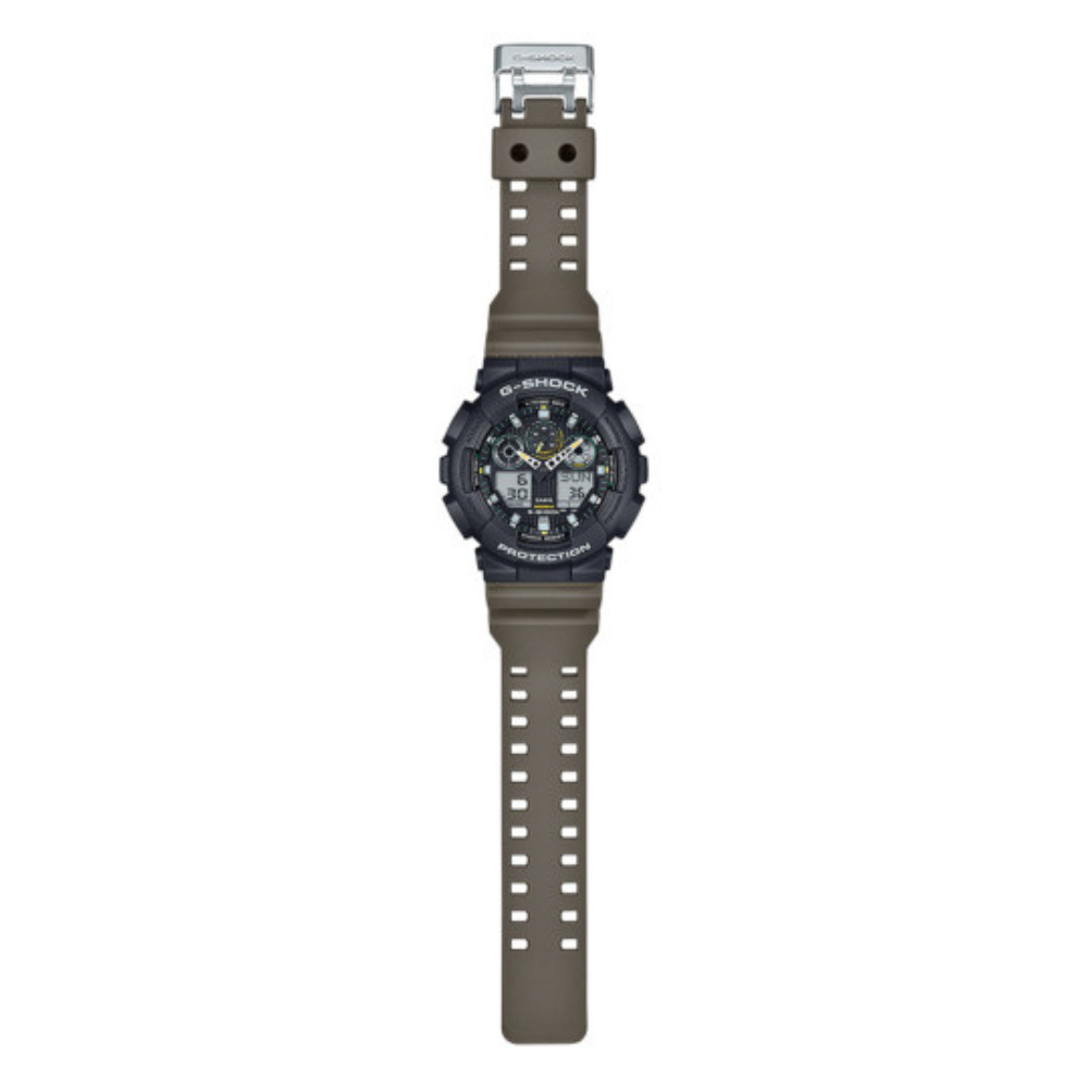 Montre-bracelet G-Shock GA-100TU noire et vert olive de Casio, robuste et moderne avec cadran en verre minéral et bracelet en résine, affichages LCD et aiguilles en