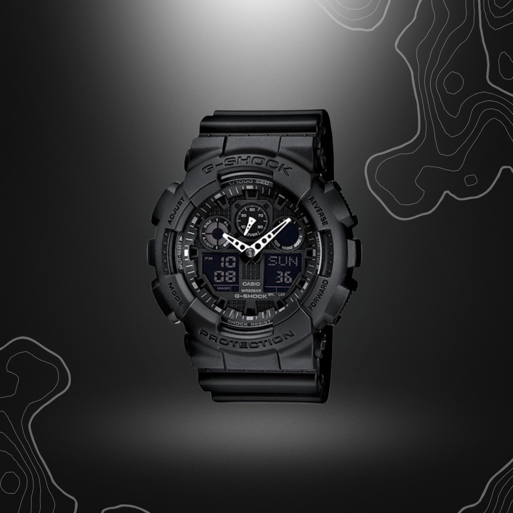 Montre G-Shock GA-100 noire de Casio avec cadran en verre minéral, bracelet en résine, affichages LCD, fonctionnalités multiples et résistance à l'eau