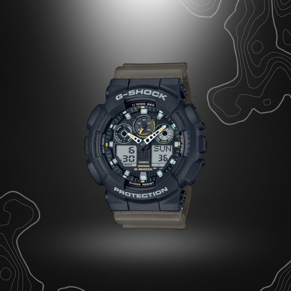Montre G-Shock GA-100TU noir/vert olive de Casio avec cadran en verre minéral, bracelet en résine, affichages LCD, résistance magnétique et multiples fonctions.