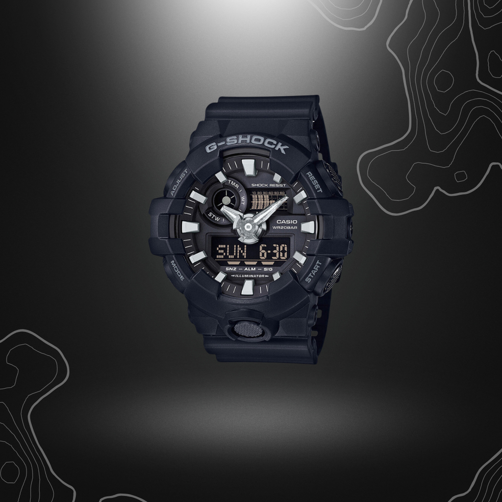 Montre G-Shock GA-700 noire de Casio avec cadran en verre minéral, bracelet en résine, affichage analogique et numérique, et multiples fonctionnalités.